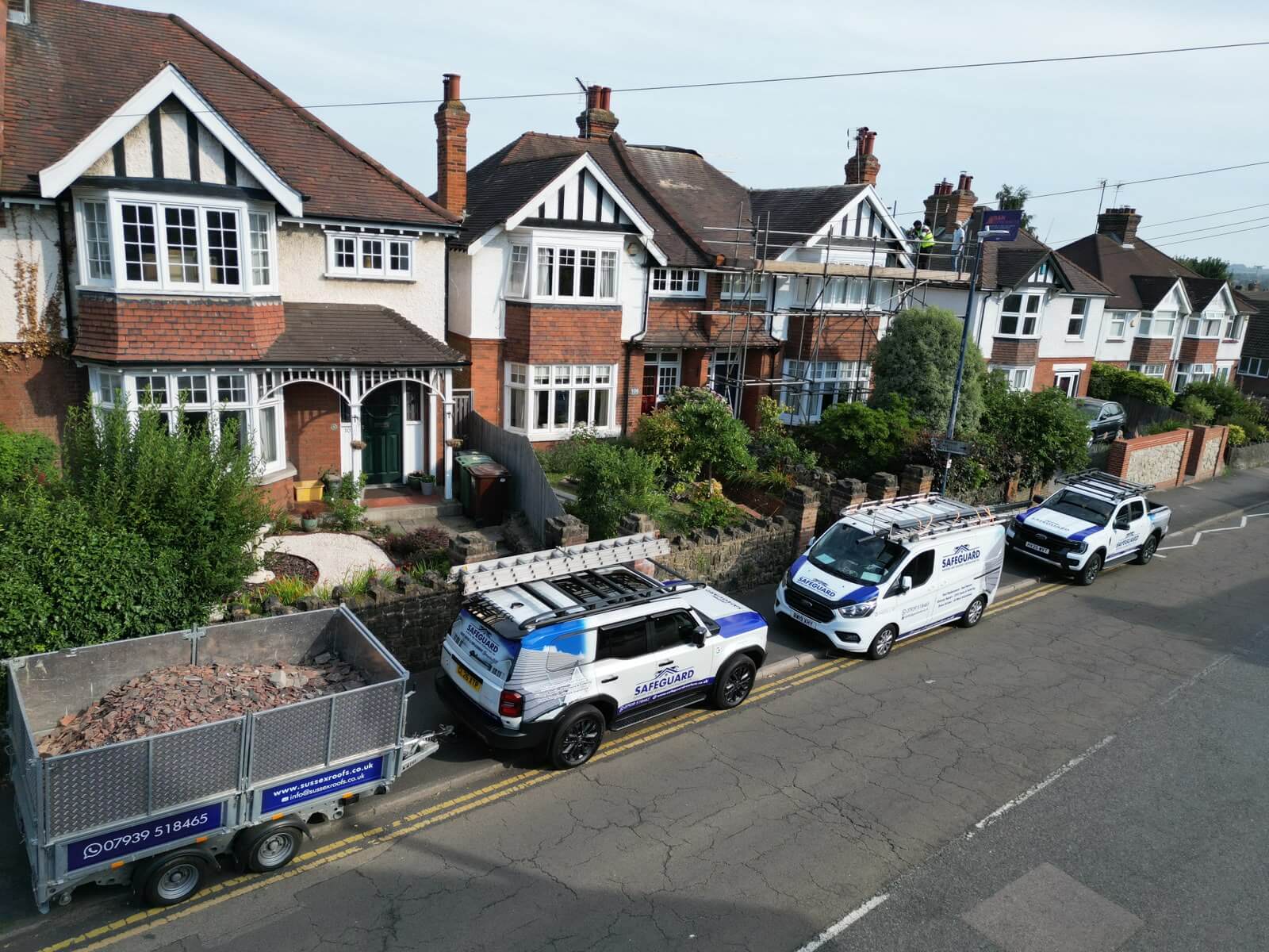 safeguard roofing vans outside a home